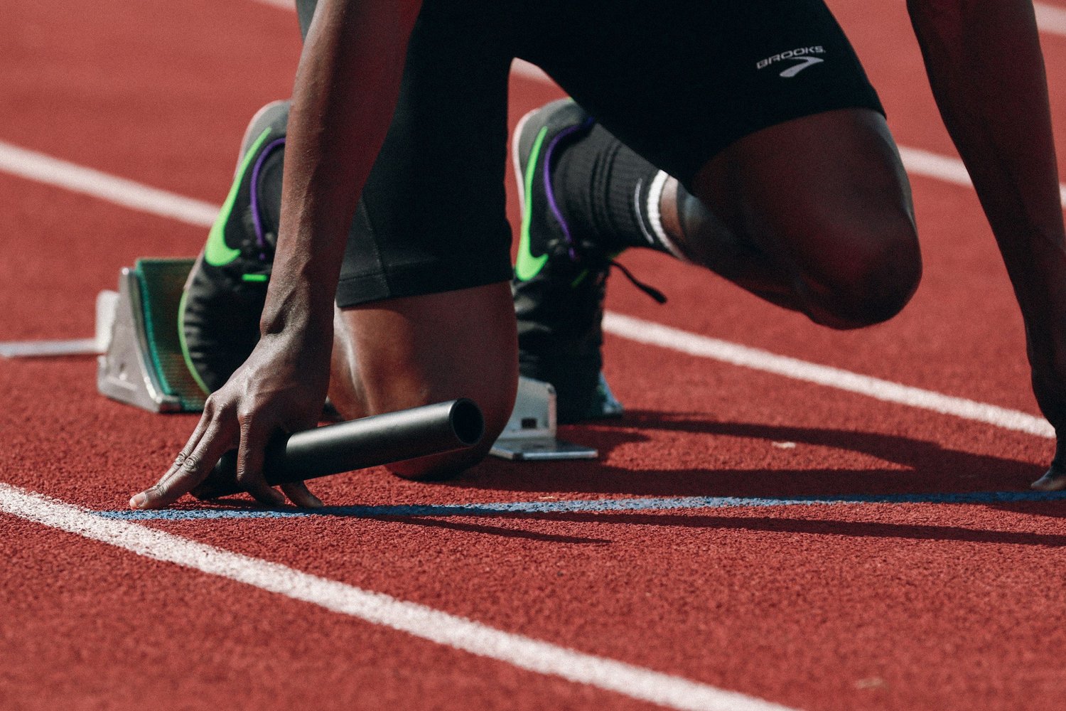 Athlete at sprint starting blocks on track
